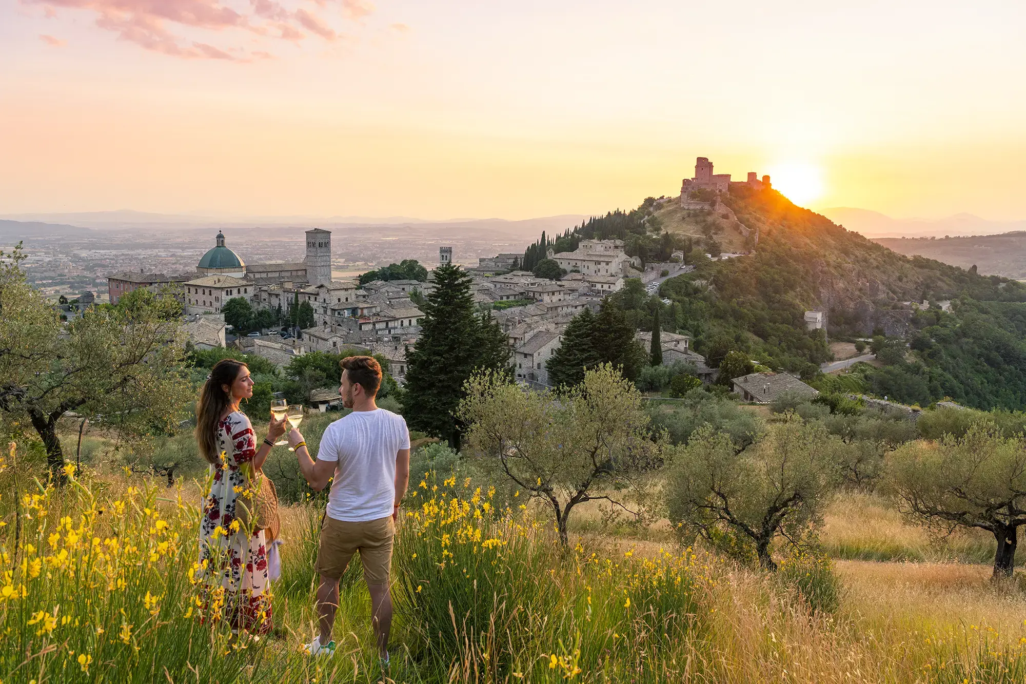 friends-toasting-wineglasses-at-sunset-assisi-italy-1272319395.webp