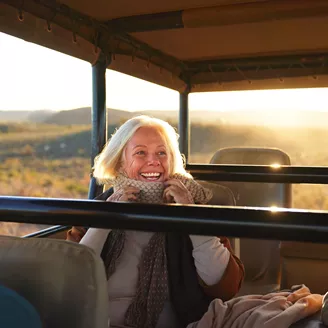 Older woman smiling while on an African safari