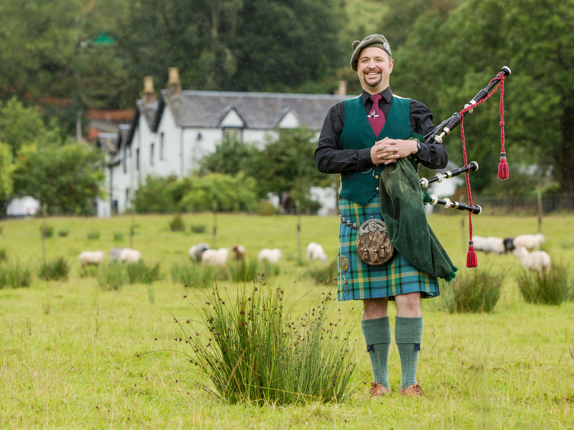 A man in traditional Scottish clothing with bagpipes