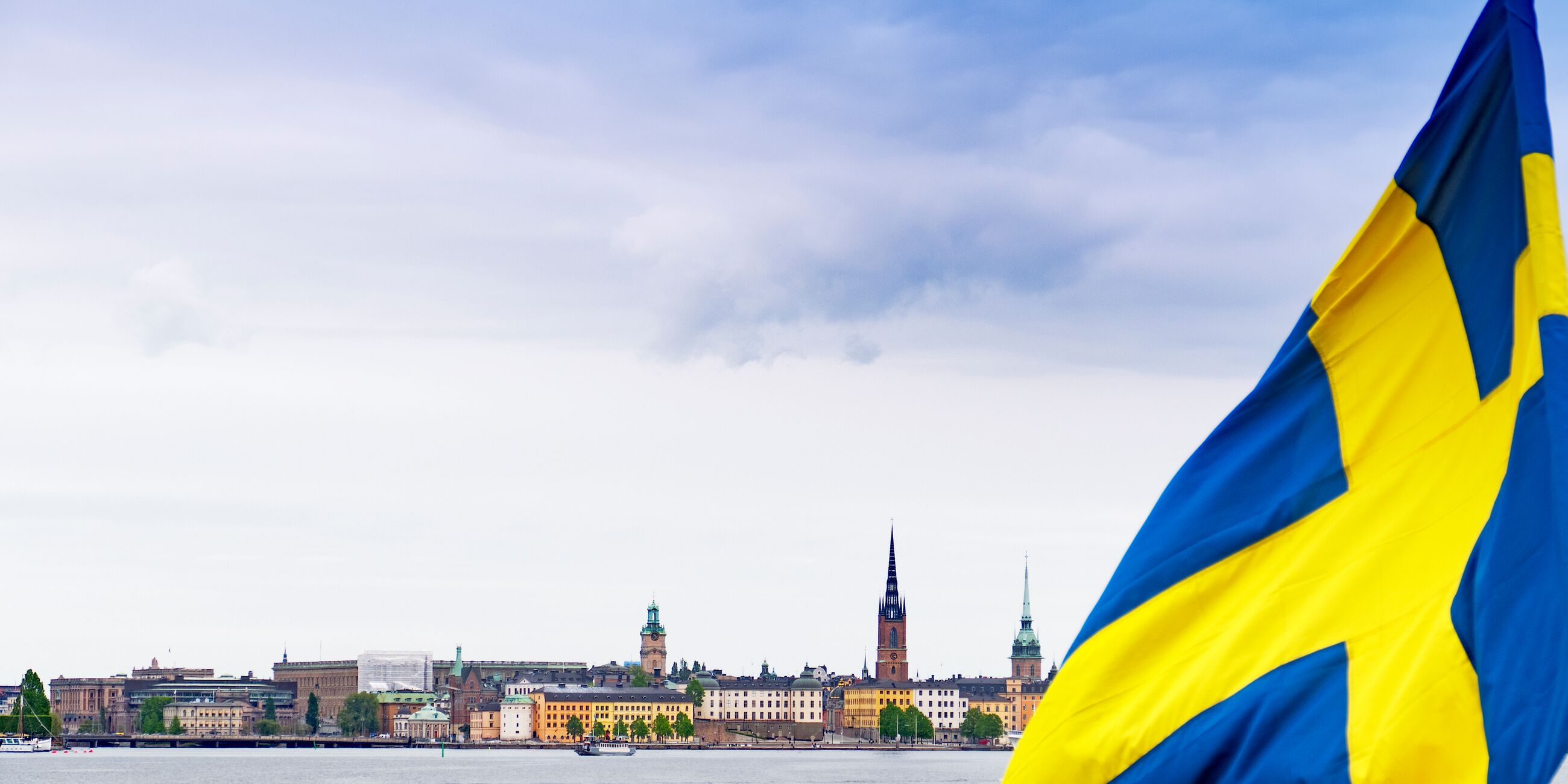 Urban Skyline Of The City Of Stockholm With The Swedish Flag