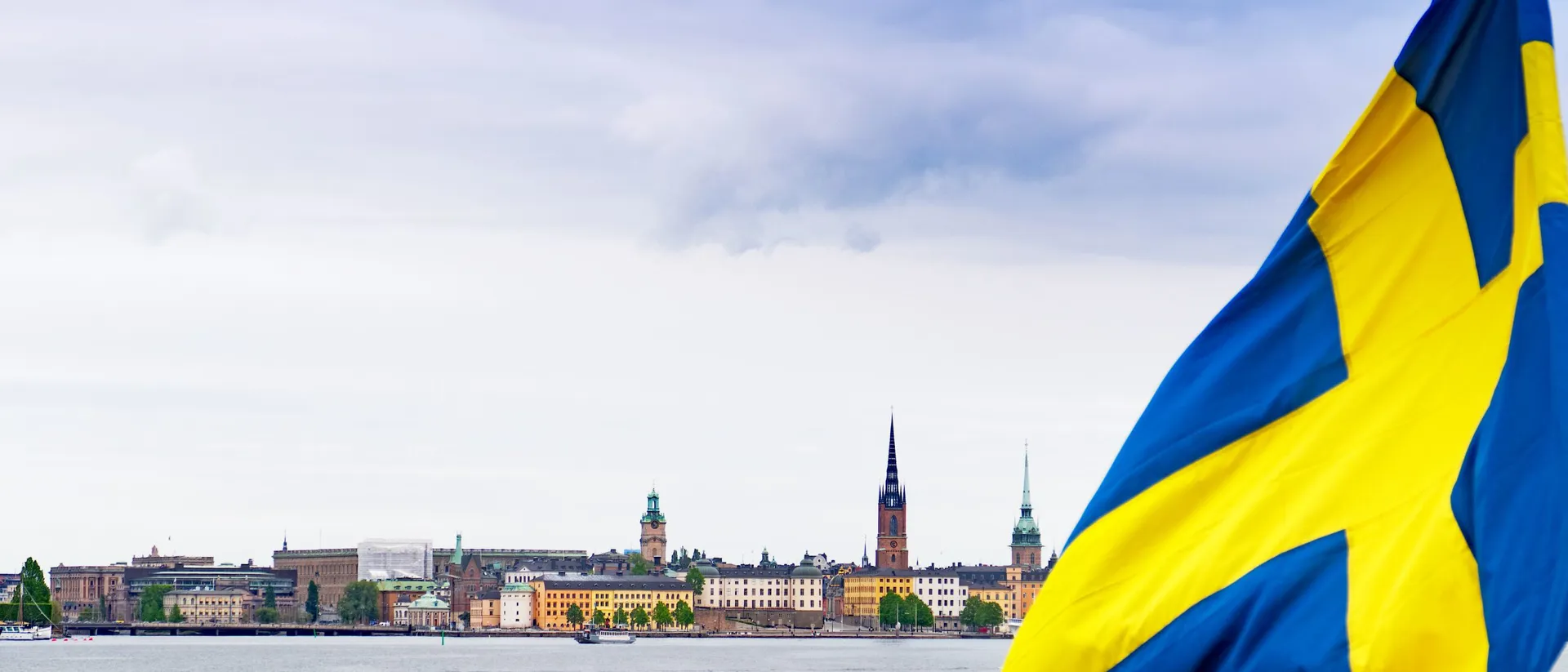 Urban Skyline Of The City Of Stockholm With The Swedish Flag