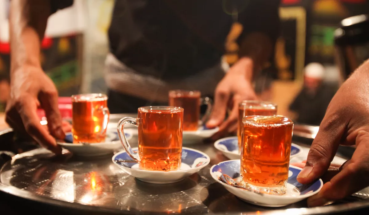 A tray of Turkish cups with tea on it