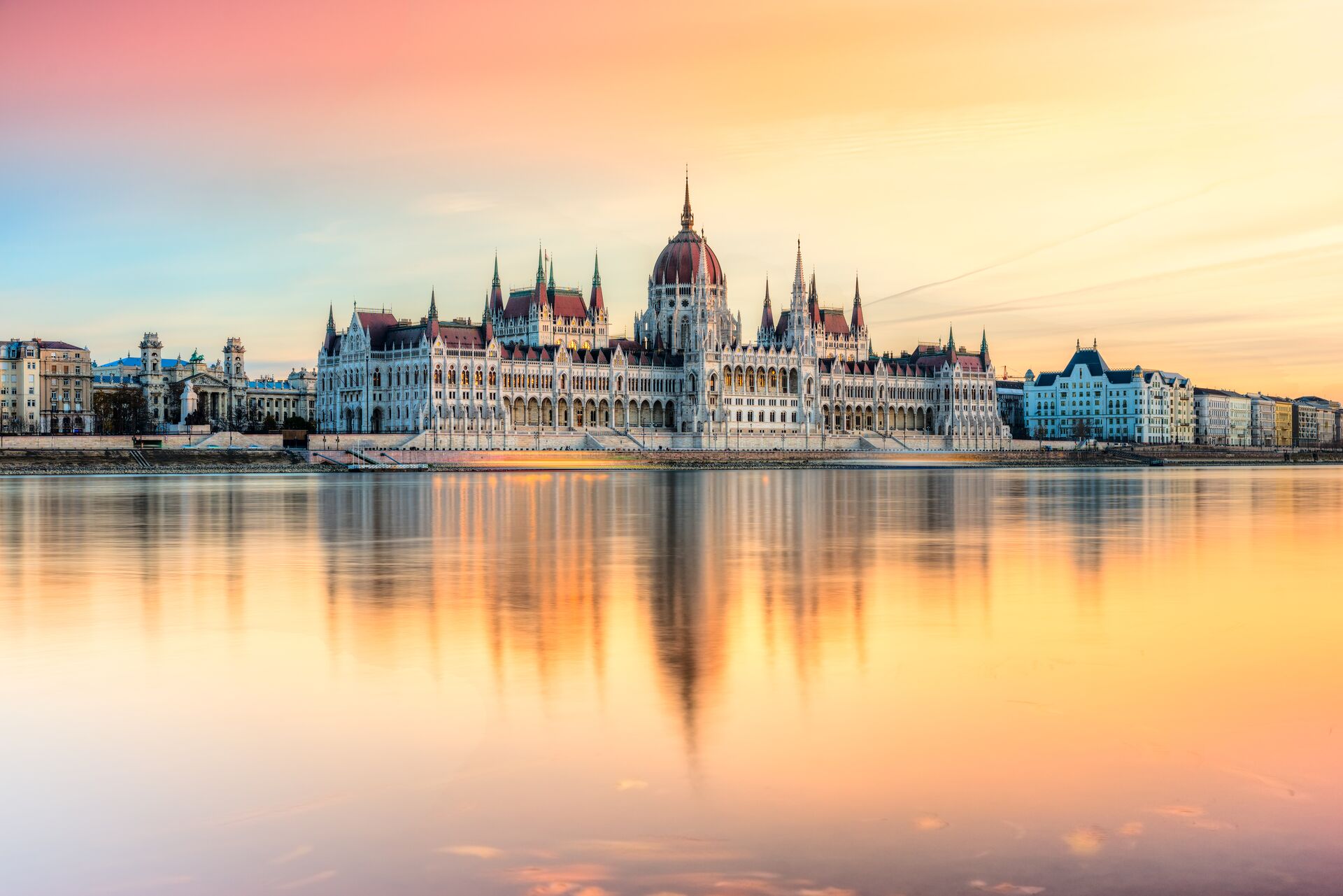 Hungarian Parliament in Budapest, reflected in a beautiful orange-hued river