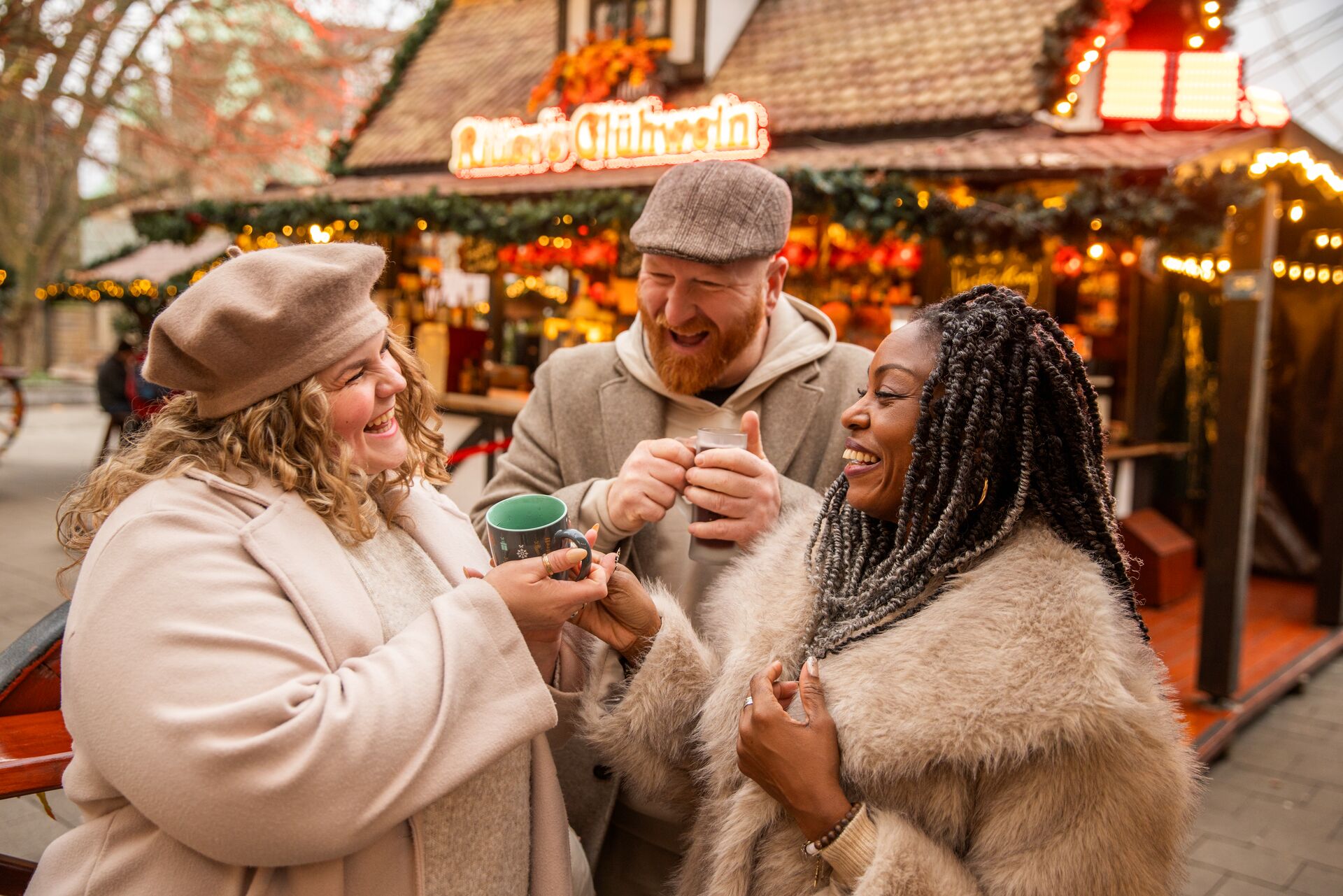 Friends chatting over Gluwein at a German Christmas Market