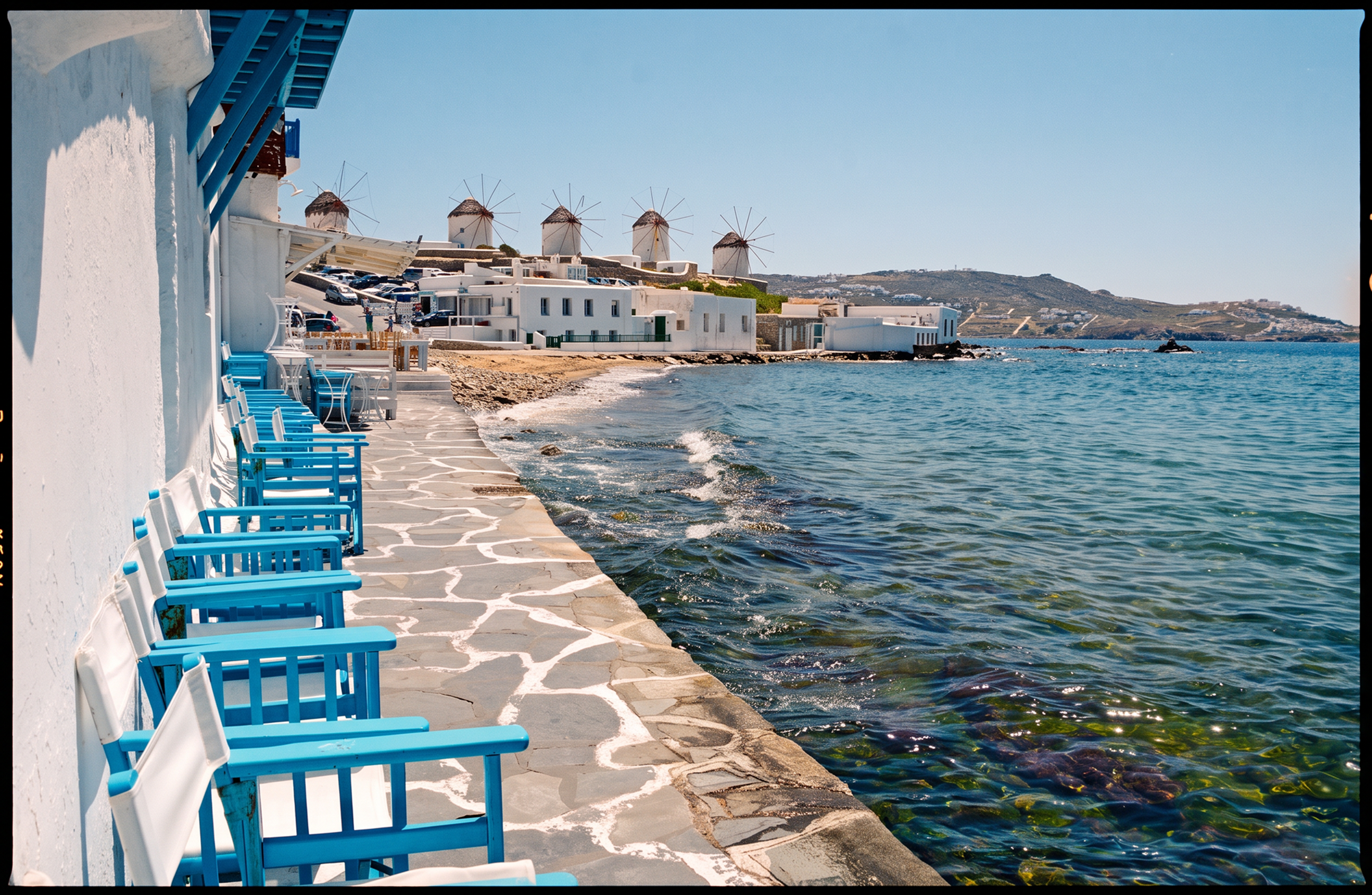 day-hero-windmills-in-background-mykonos-greece-475439772.webp