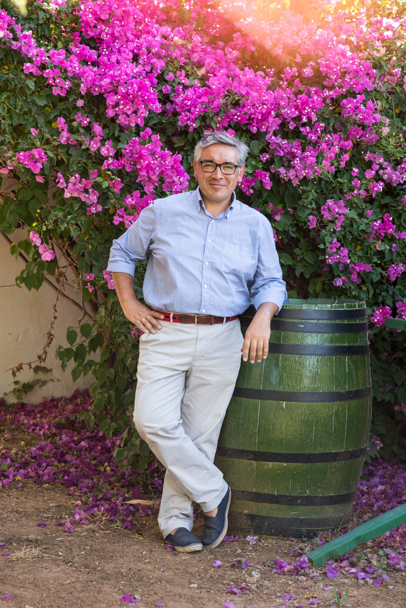 Isaac from The Morillo Family next to olive barrel from Basilippo Estate Olive Oil in Seville, Spain