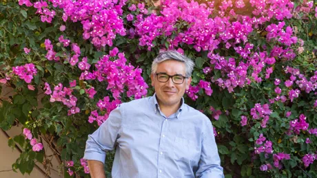 Isaac from The Morillo Family next to olive barrel from Basilippo Estate Olive Oil in Seville, Spain