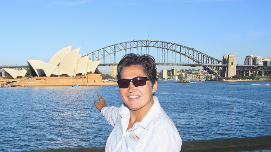 Portrait of Christin Niederle pointing at Sydney Opera House