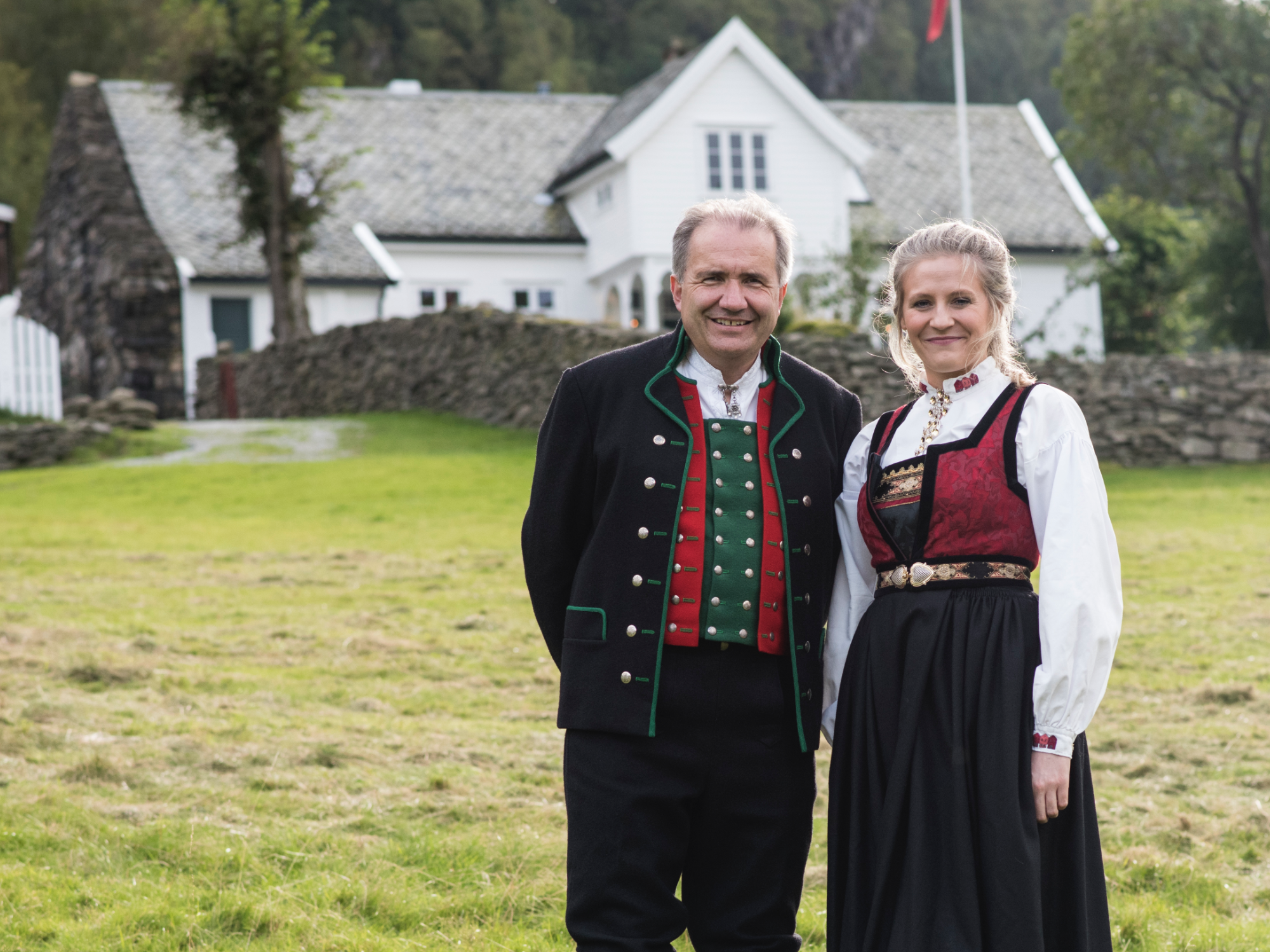 A man and woman wearing traditional clothing in Ovreeide Farm, Norway