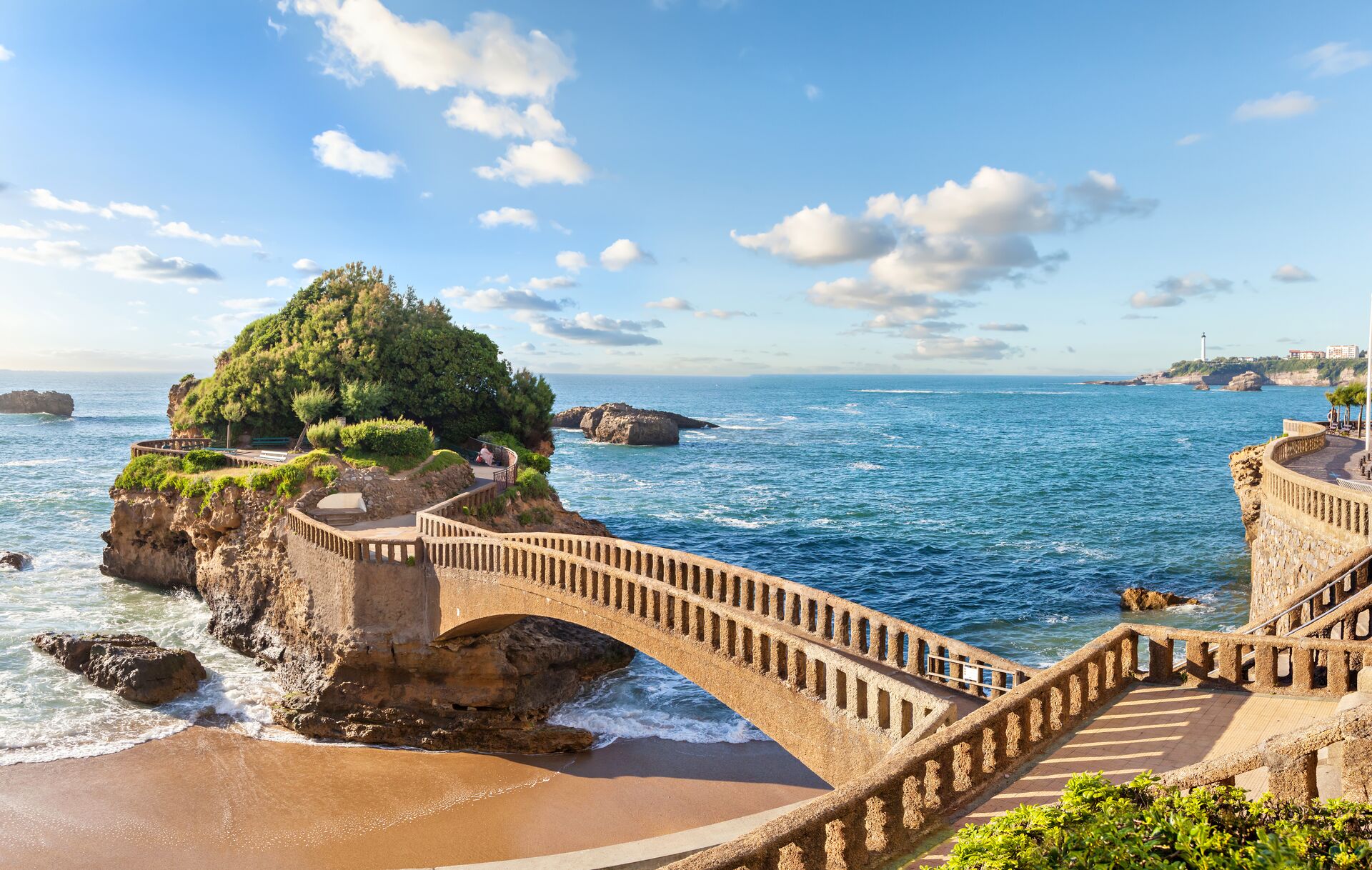 Bridge over the sparkling Mediterranean Sea to an island in Biarritz, France