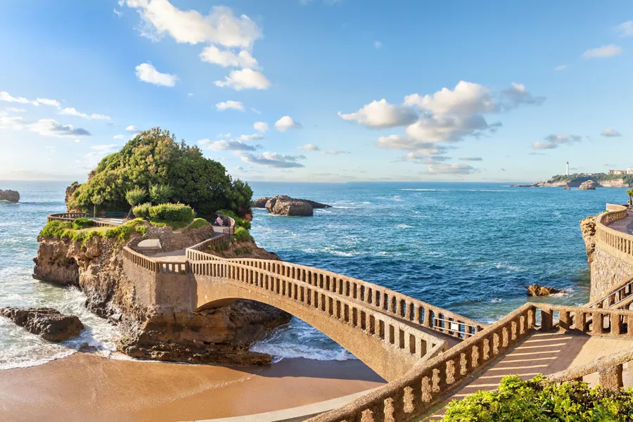 Bridge over the sparkling Mediterranean Sea to an island in Biarritz, France