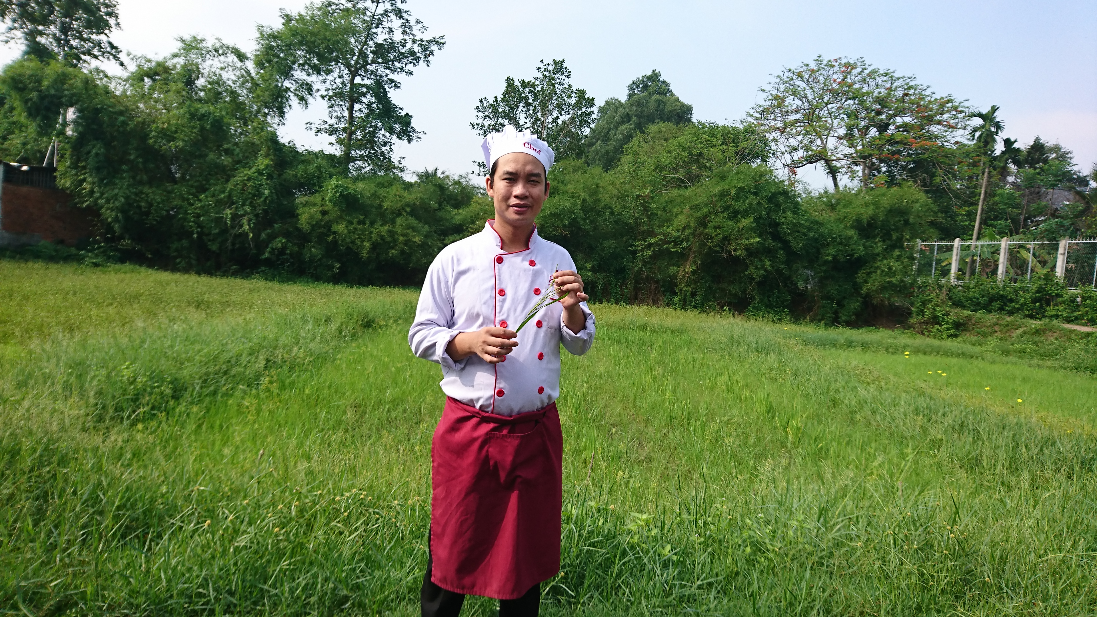 Chef Tan stood in a field