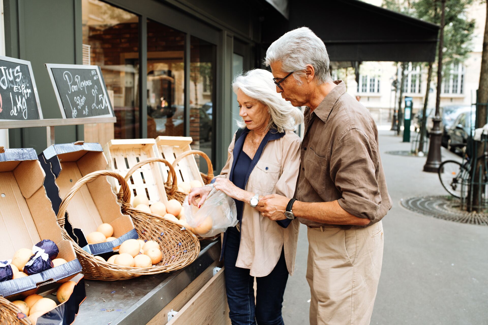 Older couple shopping at a local market in Europe