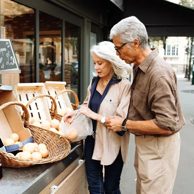 Older couple shopping at a local market in Europe