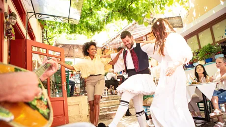 Guests Enjoying Greek Meal and Dancing in traditional outfits