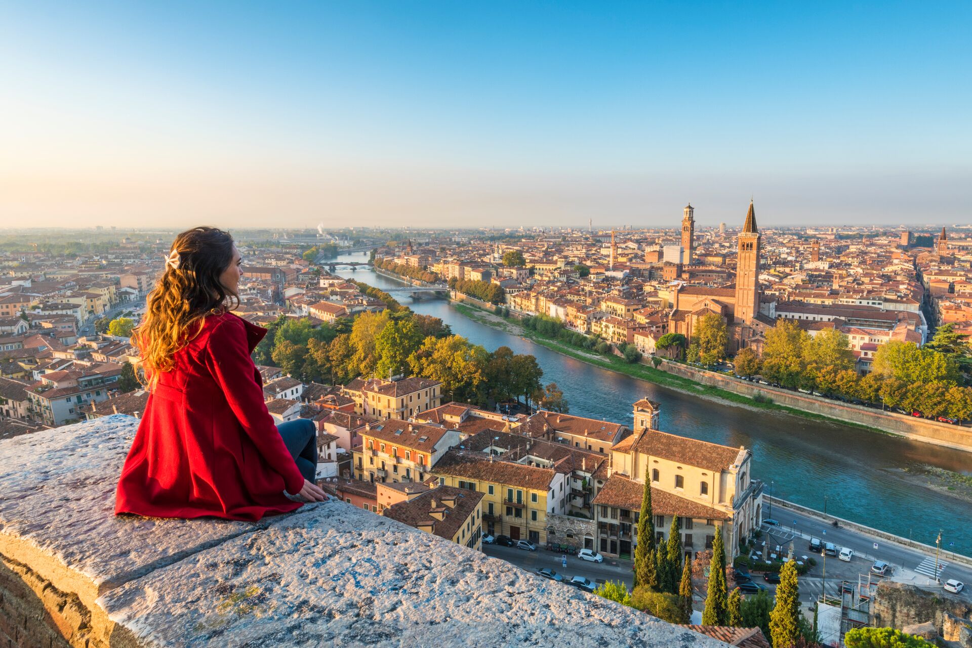 A woman admires the view of Verona's Old Town from Castel San Pietro