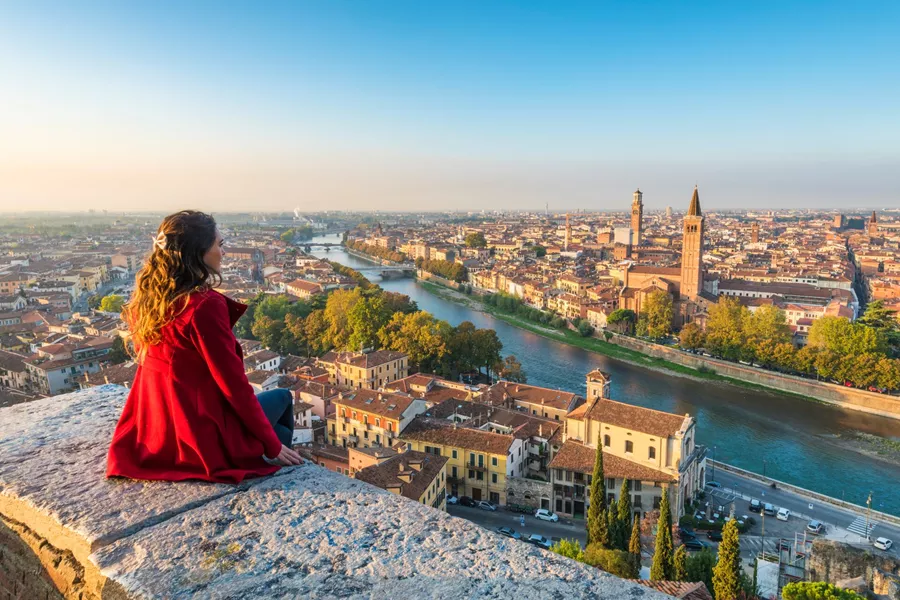 A woman admires the view of Verona's Old Town from Castel San Pietro