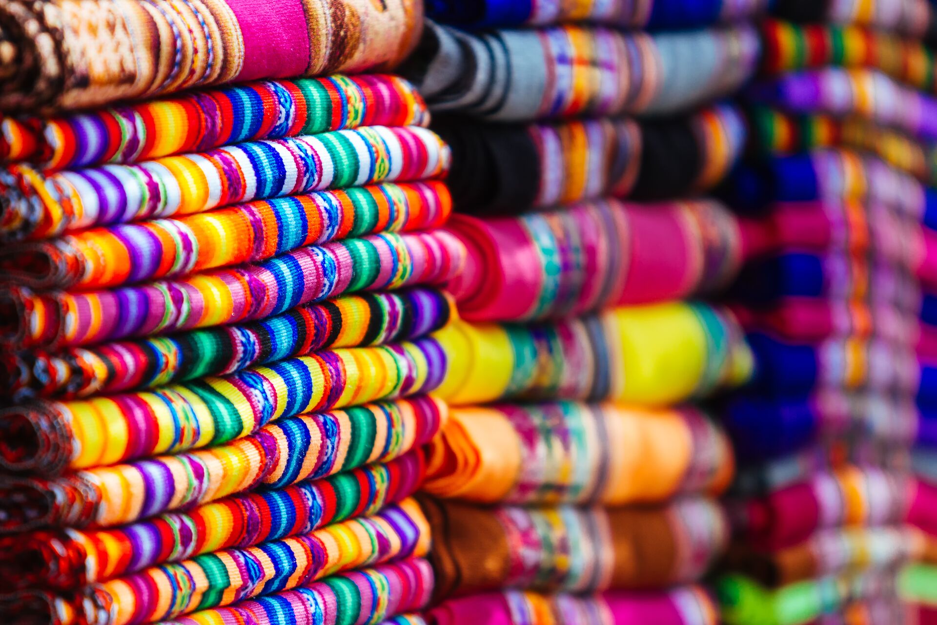 Close up of colorful blankets with Andean Designs in a local market in Peru, South America
