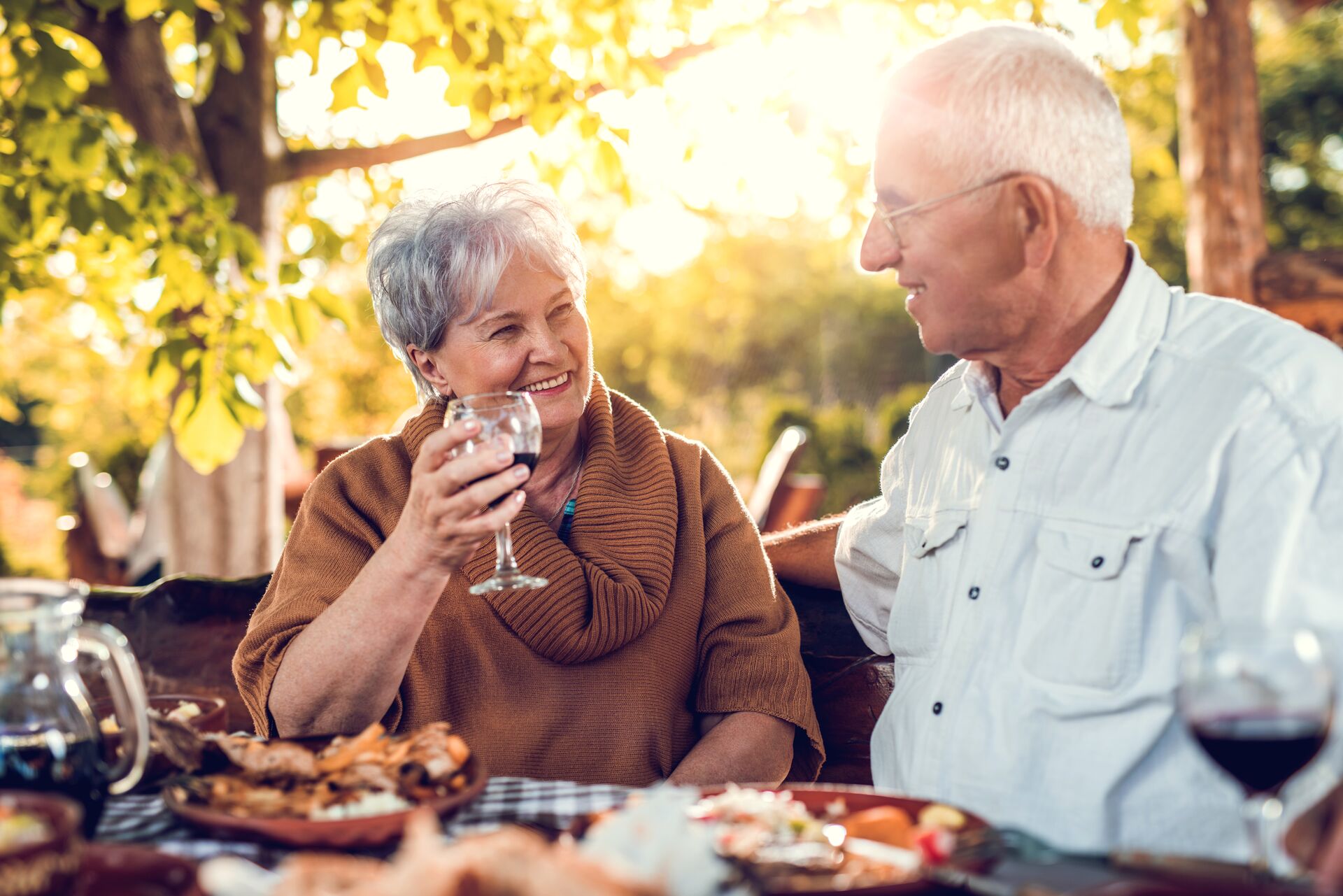 Smiling senior couple drinking wine and eating in a restaurant