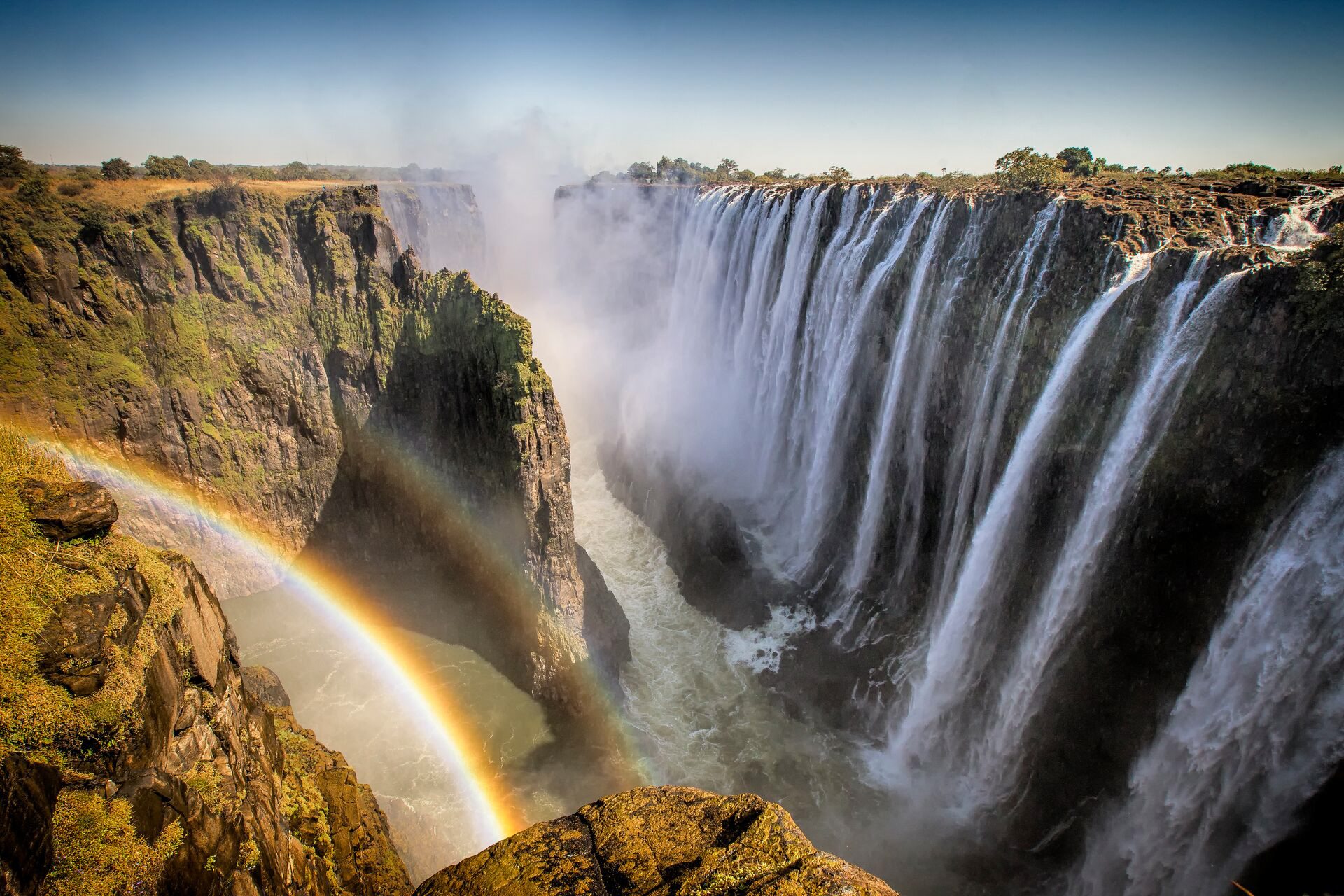 Victoria Falls creating rainbow in Zimbabwe