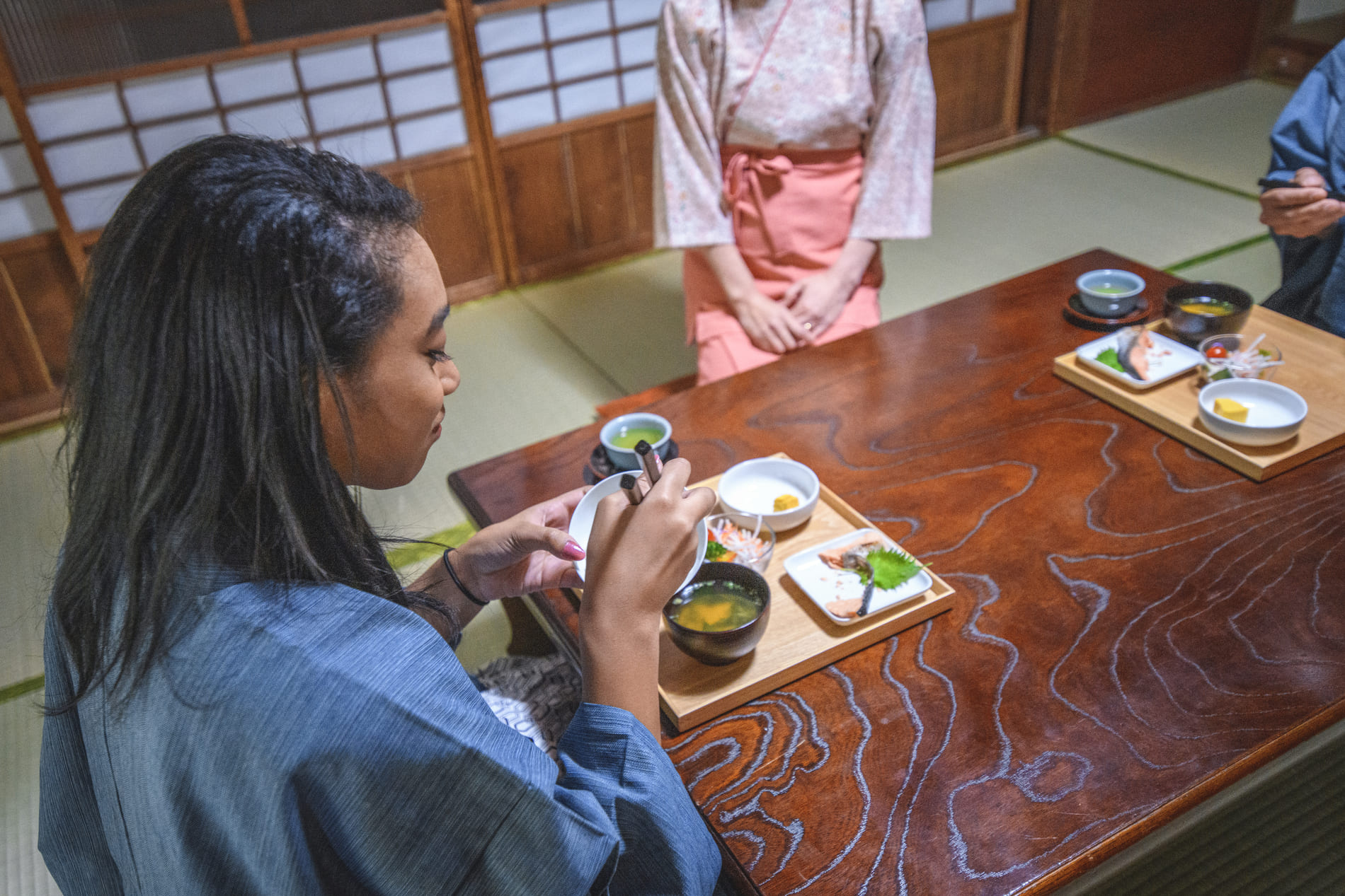 Guests and Japanese server at a Ryokan in Tokyo, Japan
