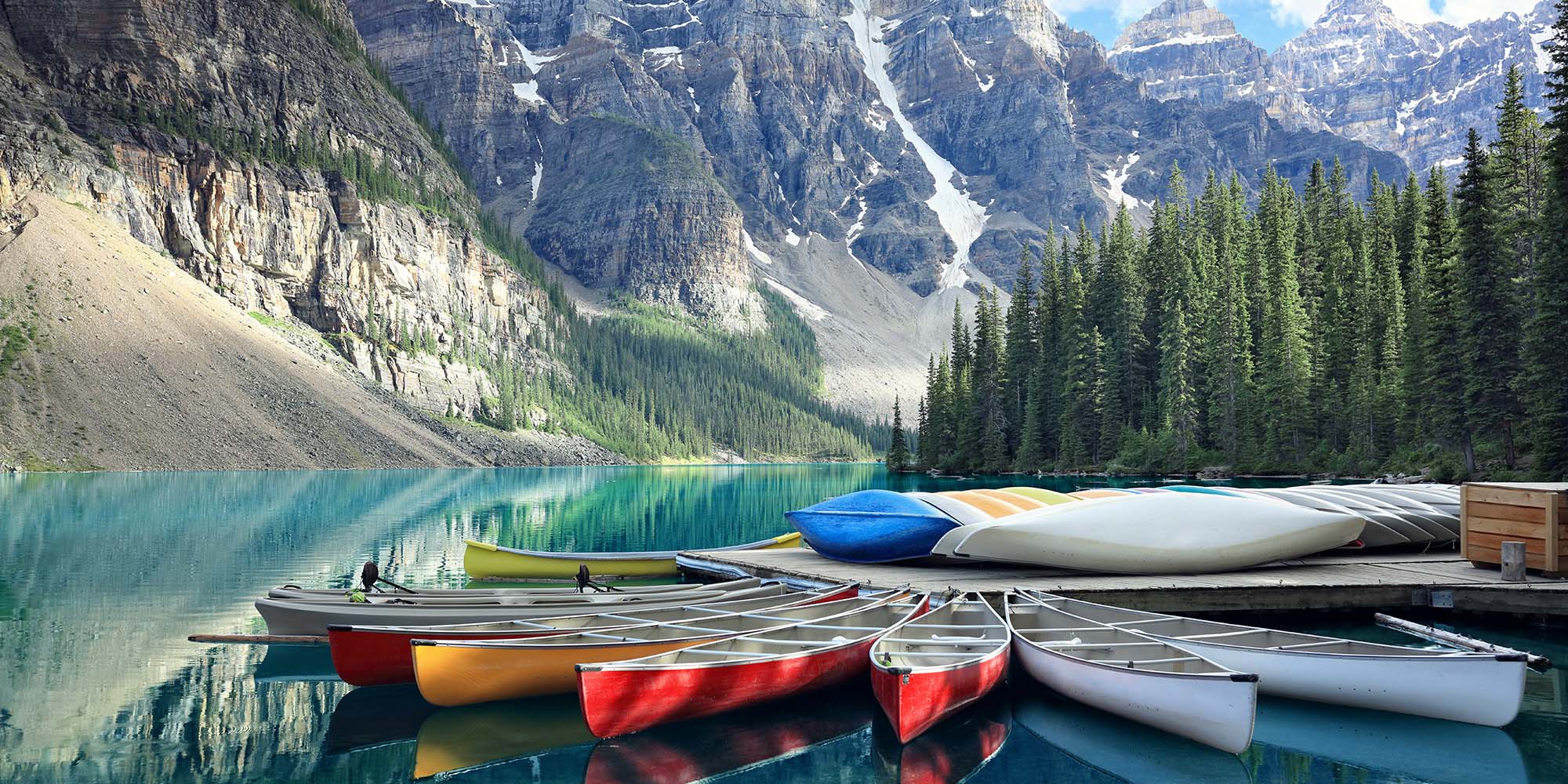 Colorful boats on Lake Moraine in Canada