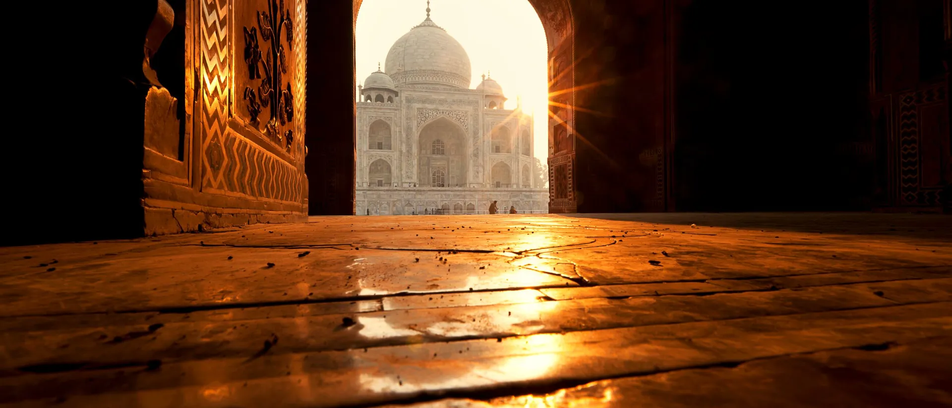 Taj Mahal temple seen through a gate of a building