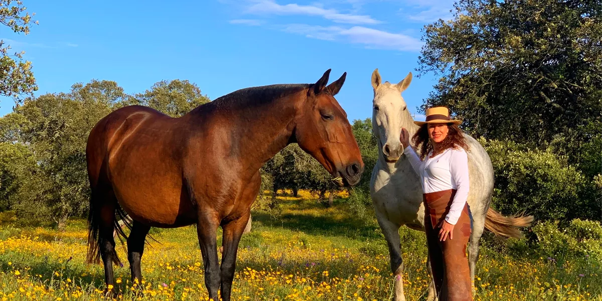 Woman with horses Tiego and Vera on a ranch in Portugal