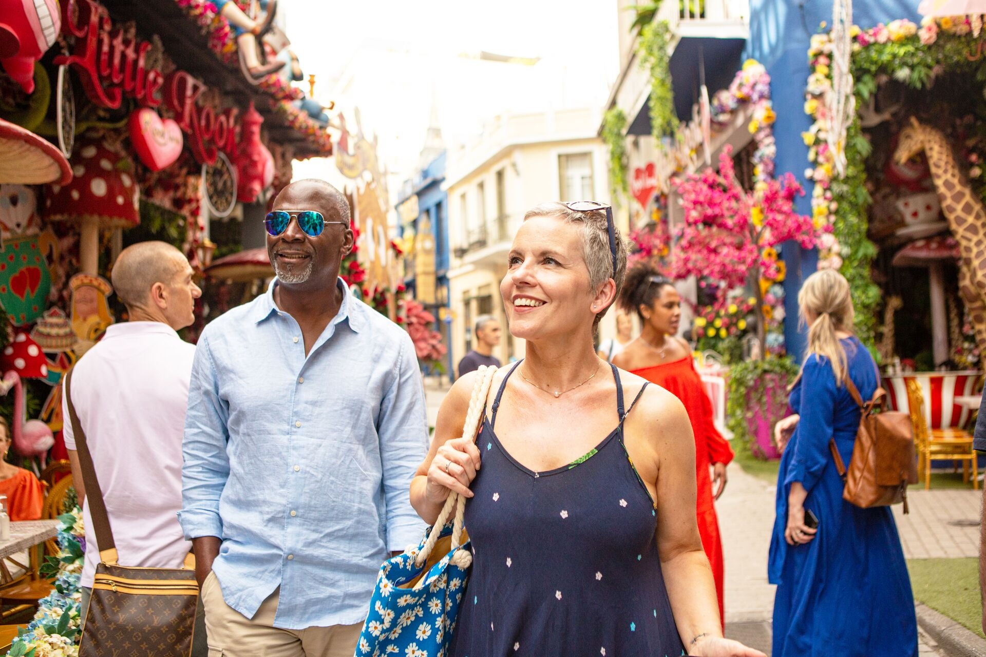 Pair of tourists walking colourful street in Athens, Greece