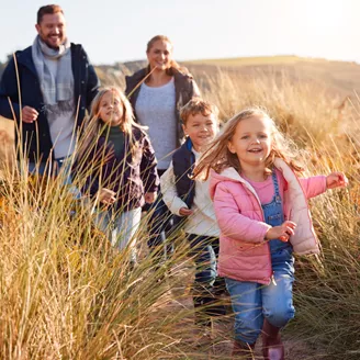 Family through sand dunes together