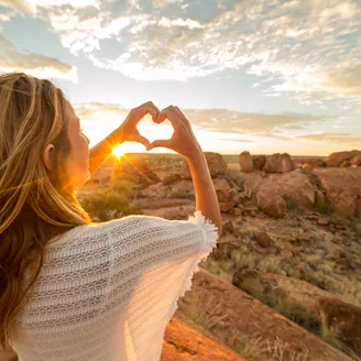 Woman watching sunset in the mountains