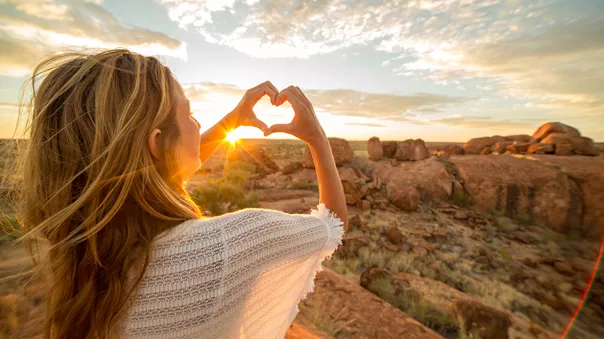 Woman watching sunset in the mountains