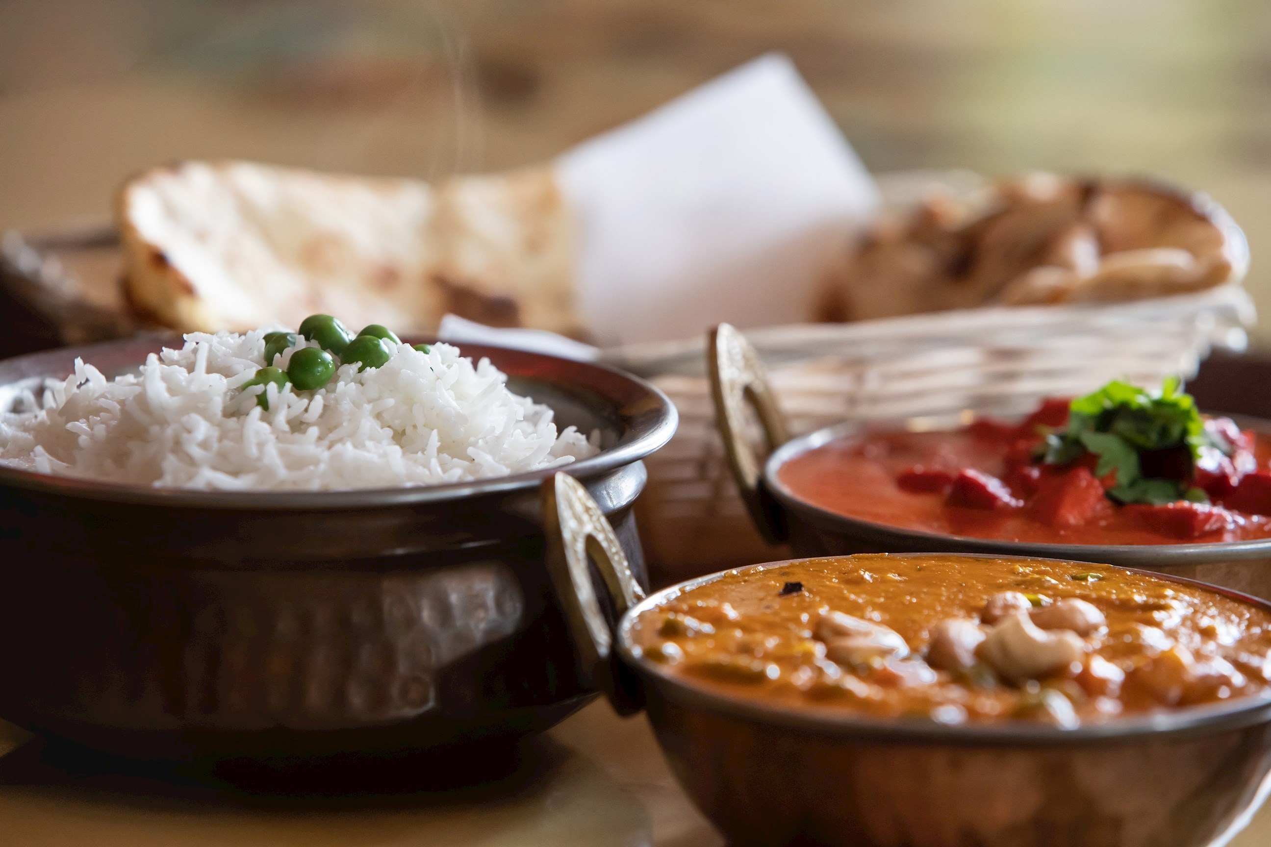 Traditional Sri Lankan dishes served in bowls on wooden table, Colombo, Sri Lanka