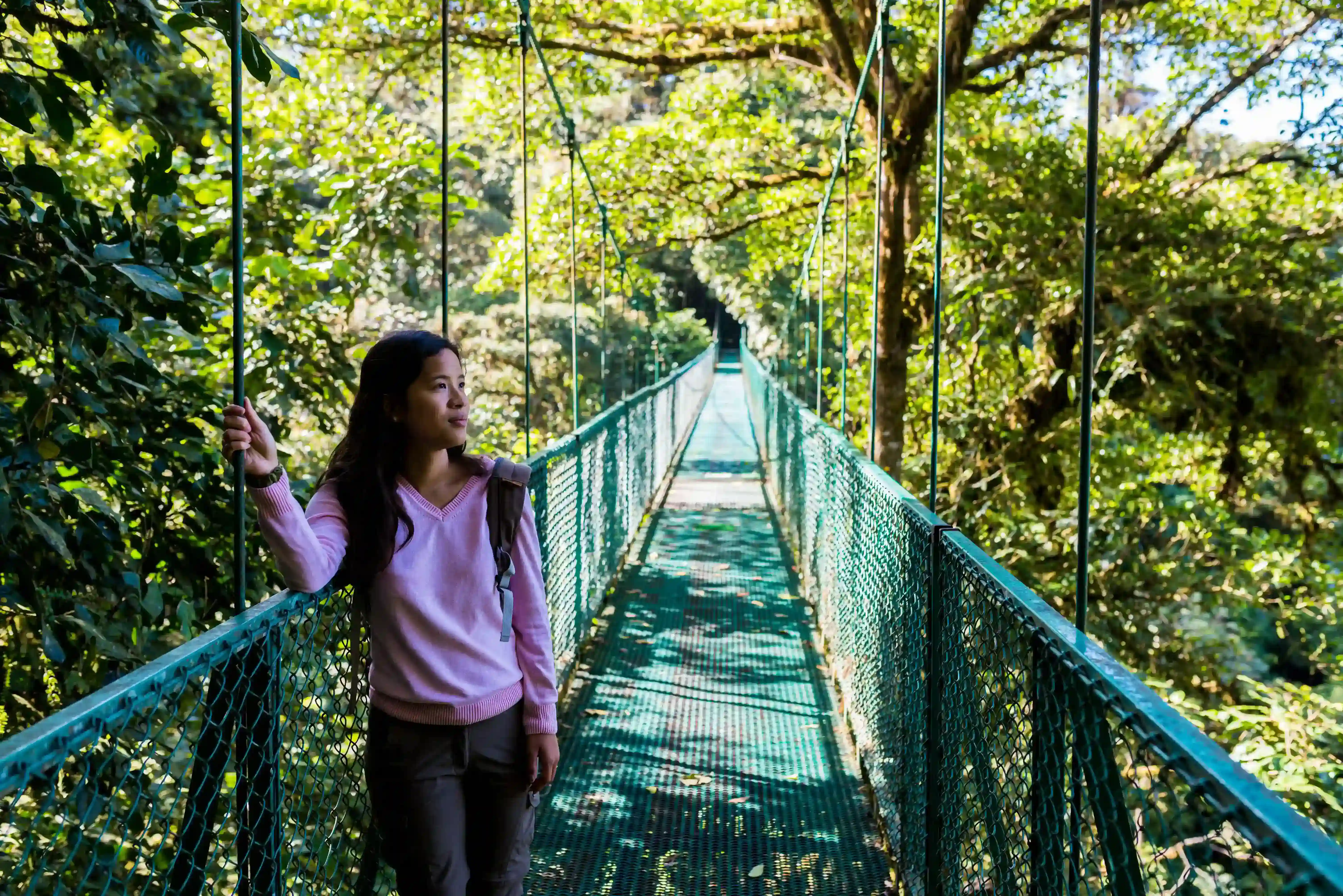 Girl Walking On Hanging Bridge In Cloudforest Monteverde, Costa Rica