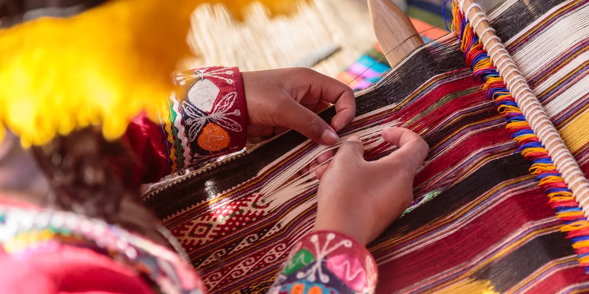 Hands Of Woman Weaving On Loom in Peru