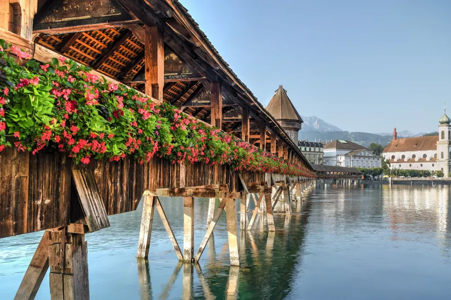 Bridge covered in flowers over water in Lucerne, Switzerland