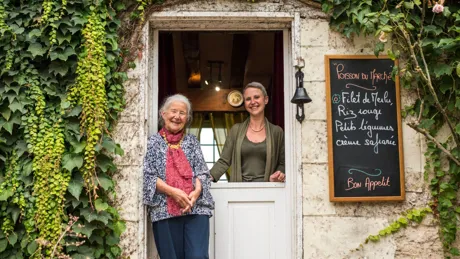 Alexandra and Beatrice Montferrier standing at the entrance to Domaine de la Giraudiere in France