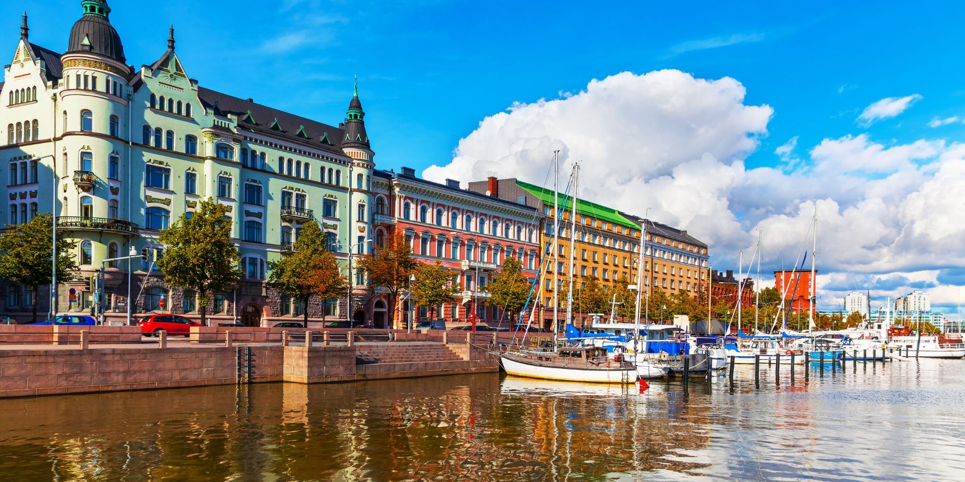 A row of colourful buildings next to a body of water in Helsinki, Finland in summer