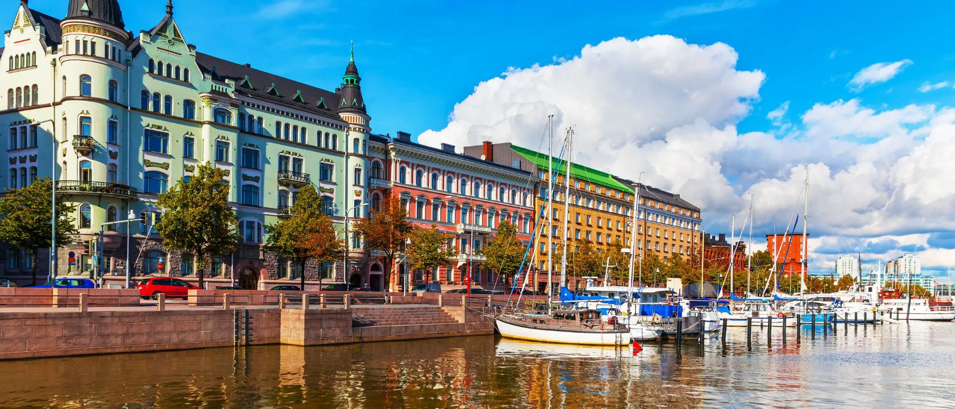 A row of colourful buildings next to a body of water in Helsinki, Finland in summer