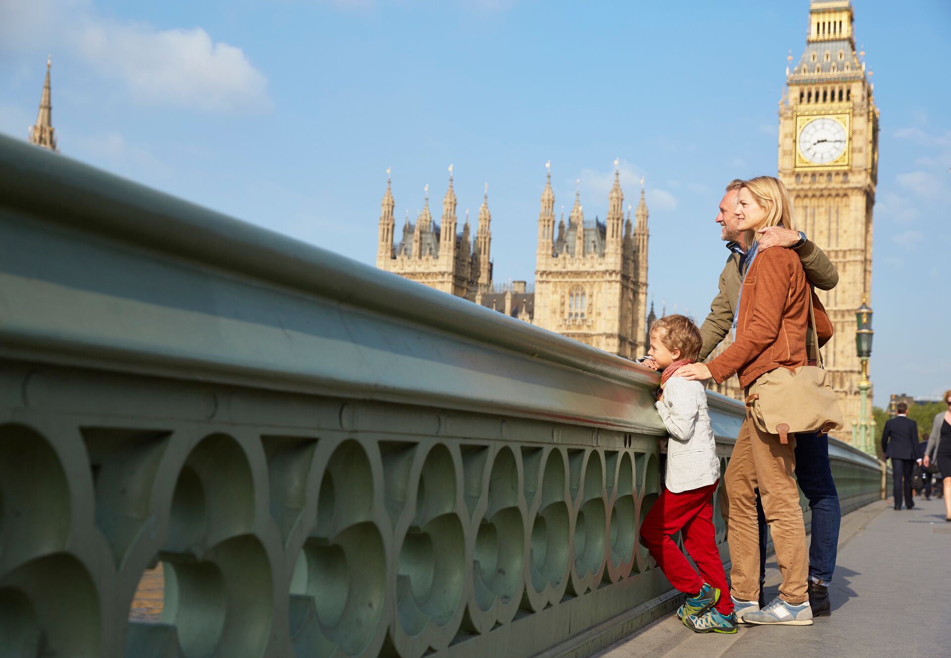 Family on Westminster Bridge looking at view while on holiday in London, England, UK