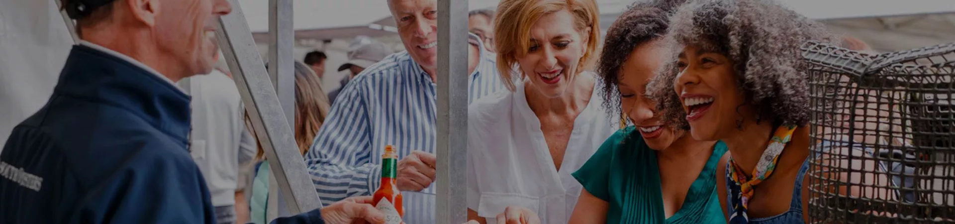 A group of people tasting local delicacies at the market