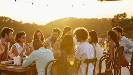 Group of travellers dining outside