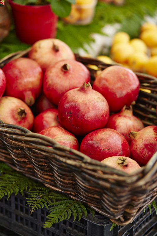 Basket full of ripe red pomegranates 