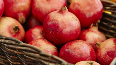 Basket full of ripe red pomegranates