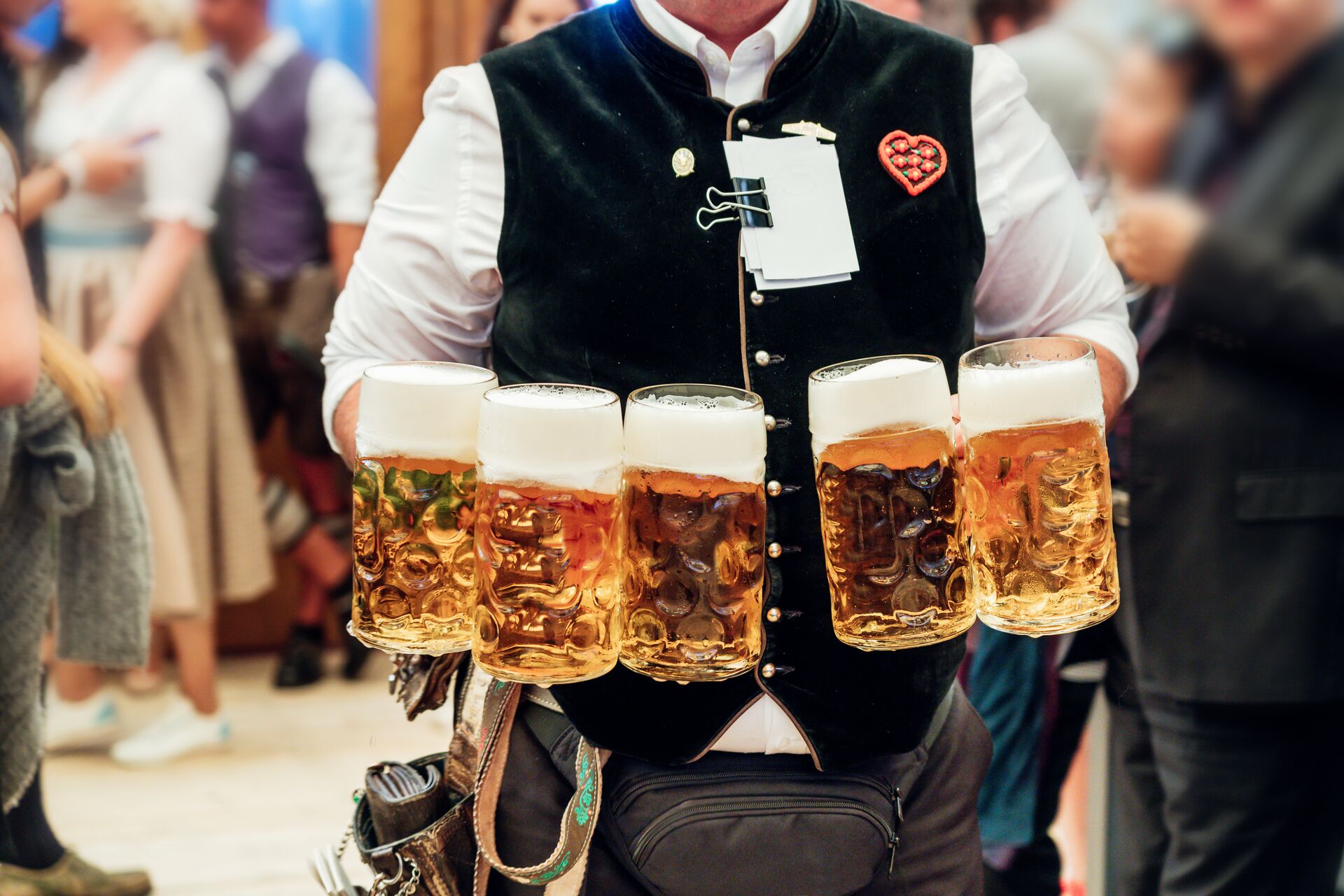 Waiter carrying beer in traditional steins