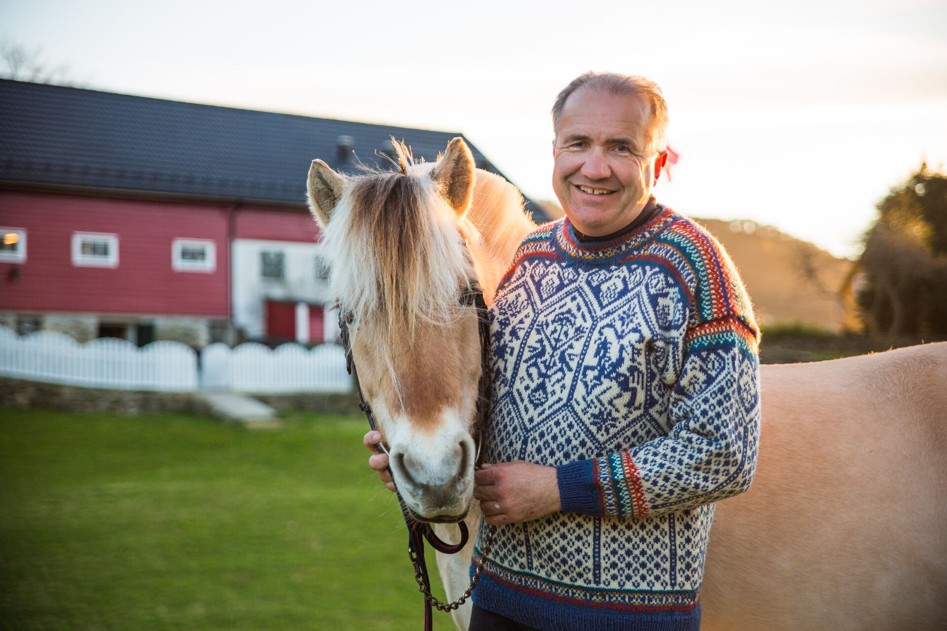 Arild standing next to a horse on Ovre Eide Farm in Bergen, Norway