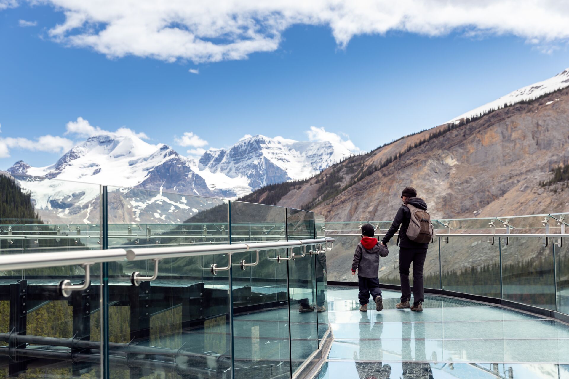 Mother and son walking on Columbia Icefield Skywalk in Jasper National Park, Canada
