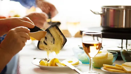 Family Eating Raclette Close Up Concept
