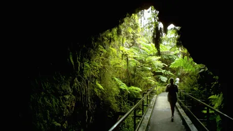 Traveller passing a bridge on UNESCO Hawaii Volcanoes site