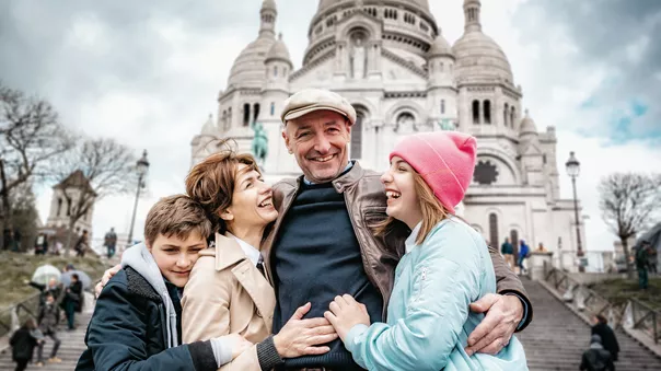 Happy French Family Embraced In Front Of Sacre Coeur In Paris 696612508